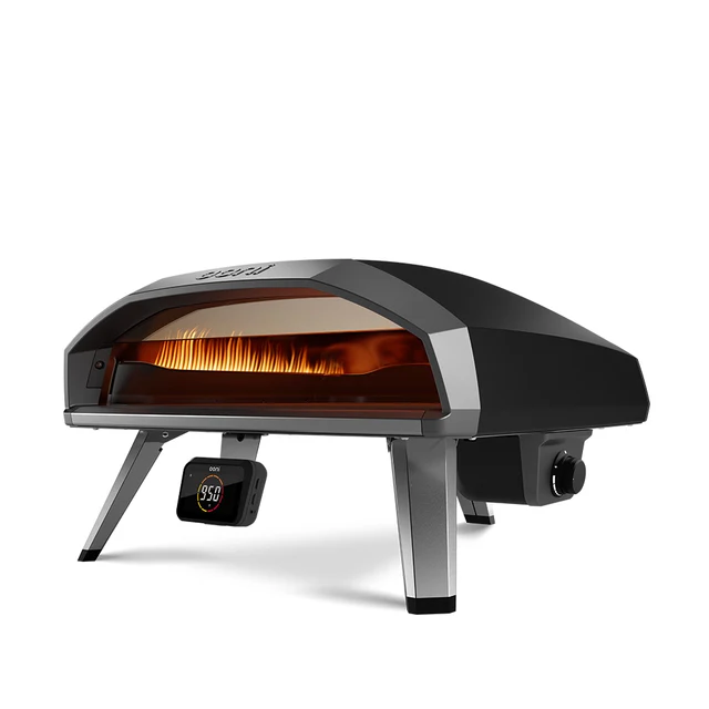 Koda 2 Pro 18-inch gas pizza oven glowing orange at dusk in a UK garden